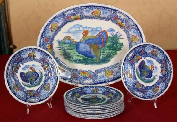 Flo Blue Polychrome 11 Pc Turkey Service Set: Flo Blue Polychrome 11 Pc Turkey Service Set. The 10 plates are 10 1/4" and the platter is 21" x 16 1/2"; A flo blue pattern with turkey in the center and around the border, has some red and yellow pa