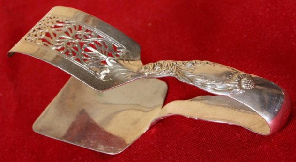 Tiffany & Co Chrysanthemum Asparagus Tongs: Tiffany & Co Chrysanthemum Asparagus Tongs; 7 1/2" Long. Tiffany's Chrysanthemum, originally called "Indian Chrysanthemum" pattern is one of best and most sought after. It was designed by Charles Gros