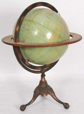 Terrestrial Globe on Stand Rand McNally eighteen i: Rand McNally eighteen inch terrestrial globe in overall good condition with some staining and a small wedge of paper loss (pictured). On an original copper finish cast iron pedistal base with claw & b