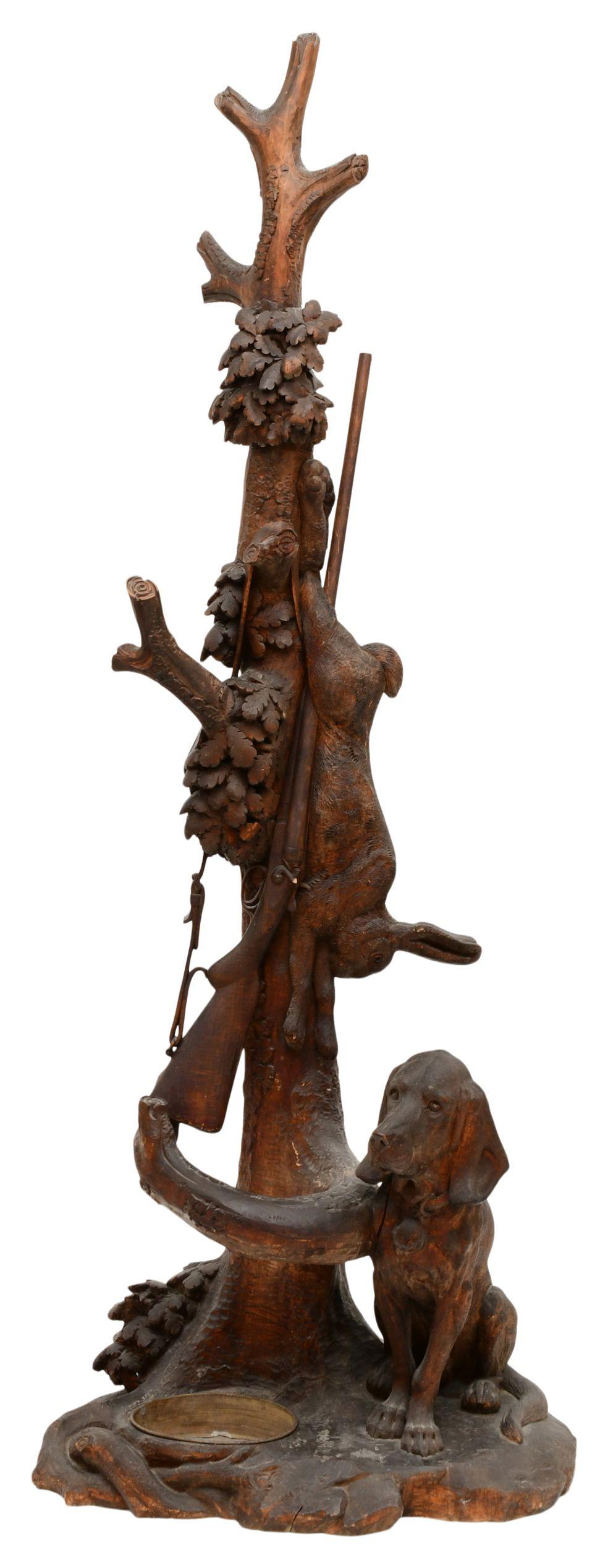Black Forest Figural Carved Umbrella Stand: Black Forest Figural Carved Umbrella Stand 19th/20th century the umbrella stand with a seated dog, hanging rabbit and rifle 80 x 31 x 20 inches
