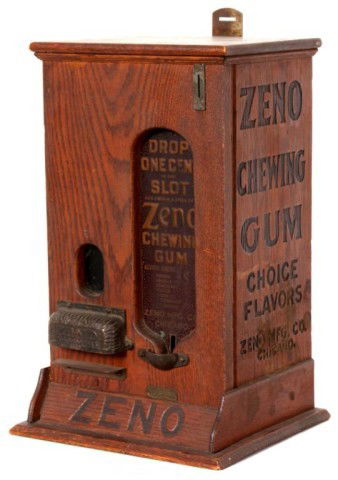 Oak Zeno 1 Cent Stick Gum Machine: Oak Zeno 1 Cent Stick Gum Machine. Rare oak case with iron mounts, carved black lettering and patined front panel above the coin return. Made in Chicago circa late 1890's. 16 1/2" x 10 1/2" x 9"