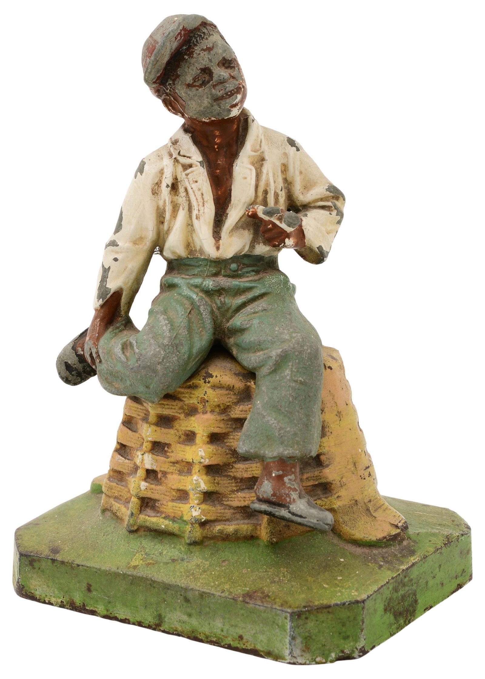 Black Americana "Boy on Basket" Doorstop: Black Americana "Boy on Basket" Doorstop 19th century the painted metal boy seated on a cast iron basket and base 7 x 5 x 4 1/4 inches