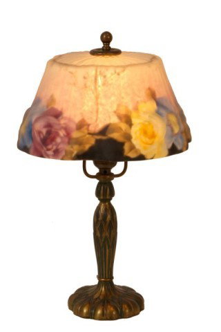 Pairpoint Puffy Dogwood Boudoir Lamp: Pairpoint Puffy Dogwood Boudoir Lamp. 8 in. Stratford shade with pink, blue and yellow flowers with green and yellow leaves, a black border at the rim and a satin pink background; signed. On a molded 
