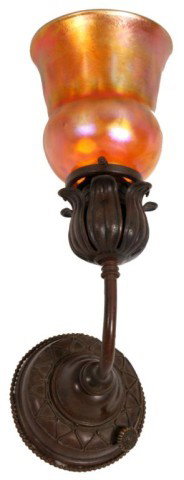 Tiffany Favrile Art Glass Wall Sconce: Tiffany Favrile Art Glass Wall Sconce. The fiery red iridescent art glass shade has bulbous top and a slightly trumpeted rim, has deep color and good iridescence, few bubbles in the glass, fitter chip