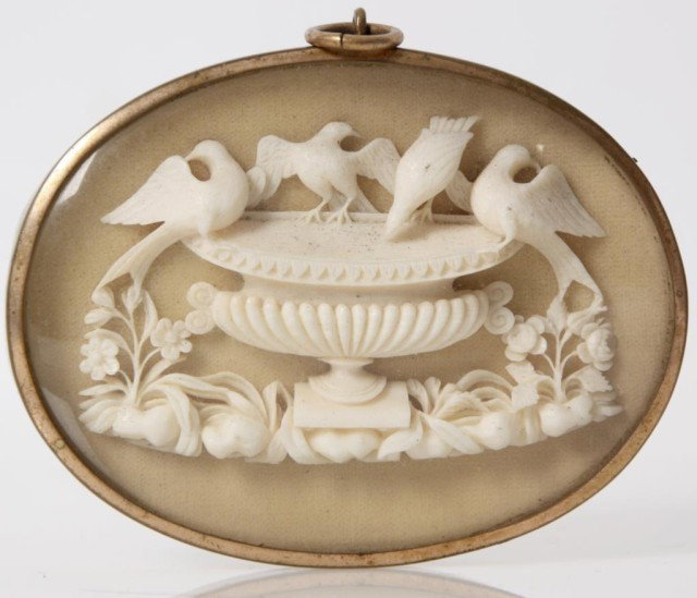 Carved Ivory Bird Bath Pendant: Carved Ivory Bird Bath Pendant. Miniature ivory carving with 4 birds drinking water from an urn in a garden; framed in a gilt metal pendant case, ivory is in excellent condition. 2.5 in. High x 3