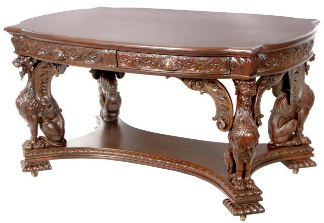 Mahogany Winged Griffin Partners Desk: Mahogany Winged Griffin Partners Desk. Full figural winged griffins seated on a convex lower stretcher. Has an unusual shaped top with a single right hand drawer on the front and back with carved apro