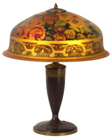 Pairpoint Reverse Painted Table Lamp: Pairpoint Reverse Painted Table Lamp. 18 in. Berkeley shade painted with various flowers including roses and poppies on a black background, has a leafy border on a saffron colored background. On a tur
