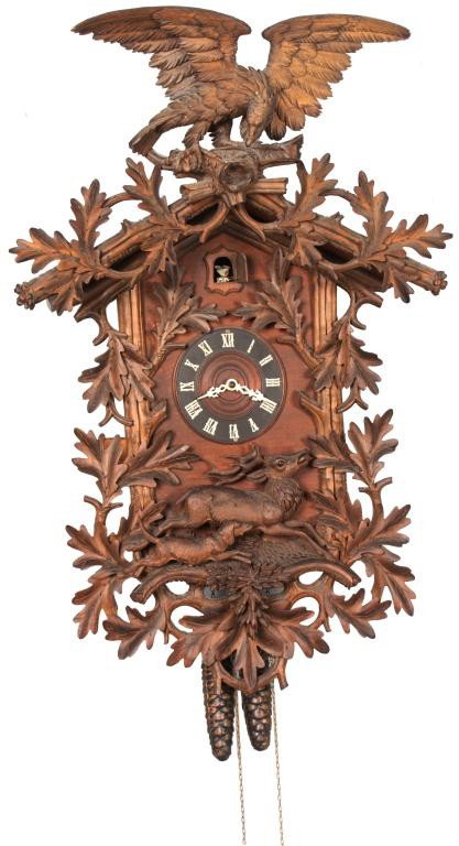 Carved Black Forest Cuckoo Clock: Carved Black Forest Cuckoo Clock. Heavily carved case with figural eagle on the crest, large oak leaves and branches on the front with a carved scene of a dog chasing a stag. 6 in. Dial with applied R