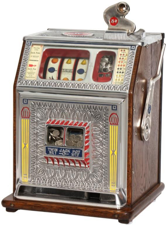 Watling 5 Cent Twin Jackpot Slot Machine: Watling 5 Cent Twin Jackpot Slot Machine. Silvered case with painted highlights, oak sides and base, has back and key, in good working condition. Has green Watling label on the side, serial number T46