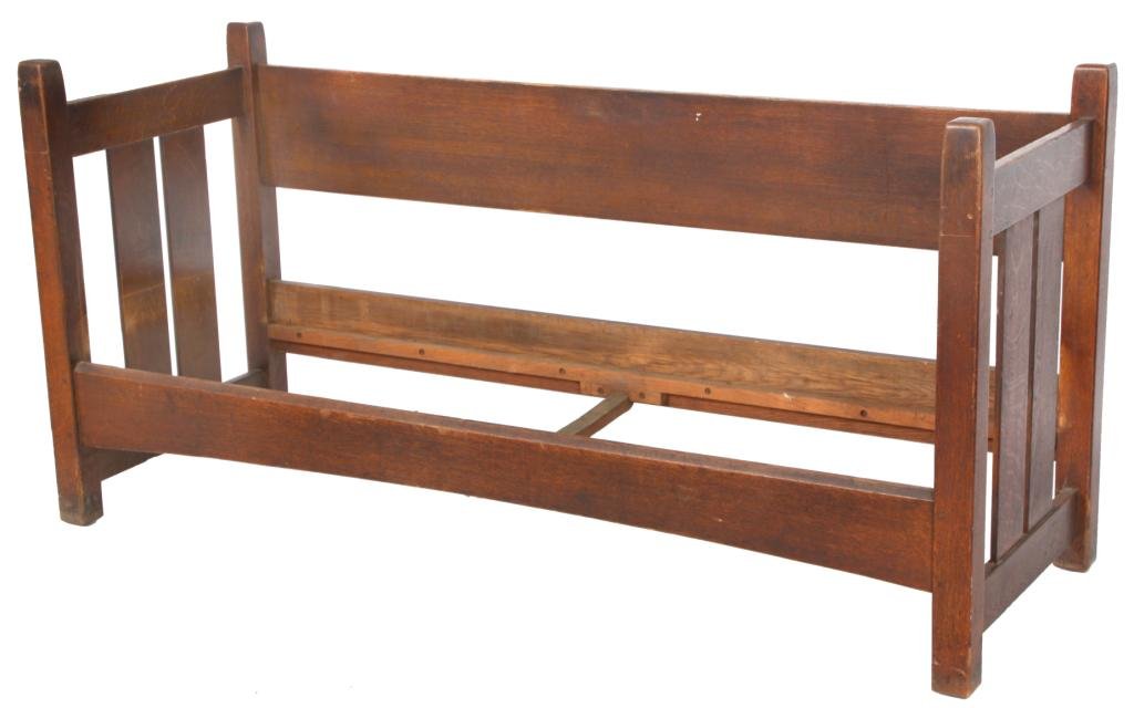 L. & J.G. Stickley #229 Slat Side Oak Settle: A large single board back with 4 legs running from the floor and tapering at the top. The side has horizontal stretchers above and below the two vertical slats in the center. The front seat rail is be