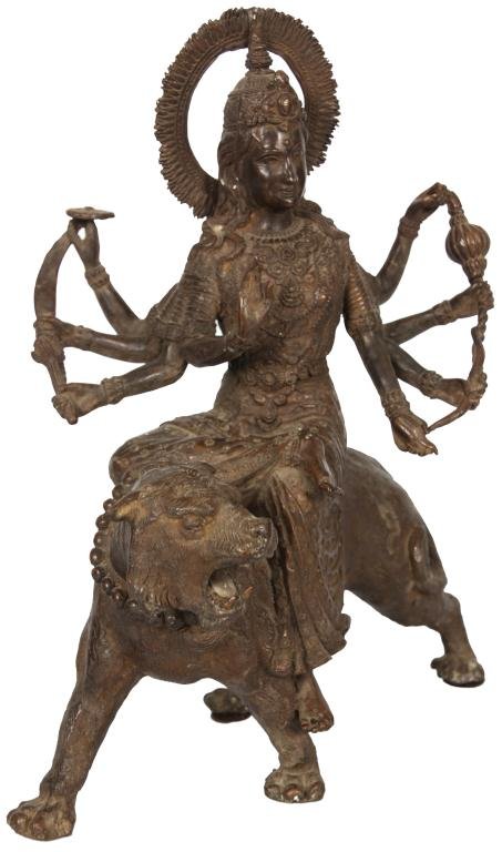 Antique Hindu Bronze of Durga: Antique Hindu Bronze of Durga. The invincible figure is depicted riding a tiger, she has a meditative smile, having multiple arms holding various weapons. Bronze is unsigned and in very good condition