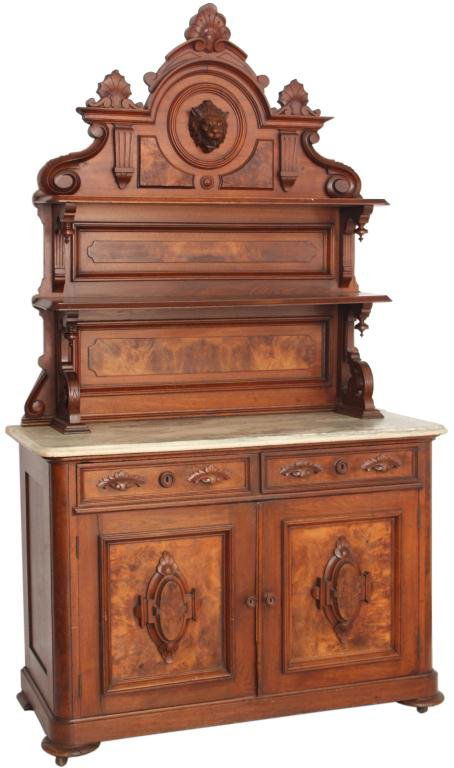 Carved Walnut Marble Top Sideboard: Victorian Carved Walnut Marble Top Sideboard w/ Lion's Head. High back with paneled sections and 2 shelves with corbeled supports and teardrop finials; the crest is centered with a lion's head having
