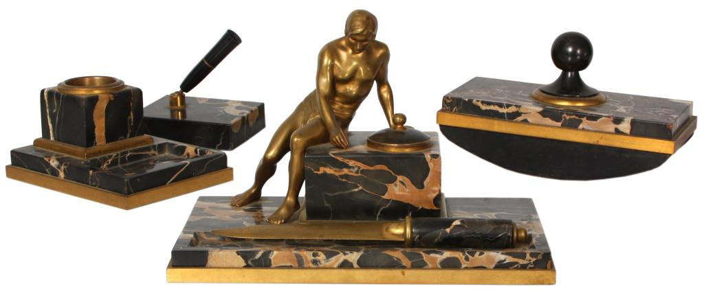 Peter Behrens 5 Pc. Desk Set: Peter Behrens 5 Pc. Desk Set. Marble and bronze desk set has a figure of a man seated on the inkwell; includes pen tray with inkwell, letter opener, 2nd inkwell, pen holder and roller blotter. The set