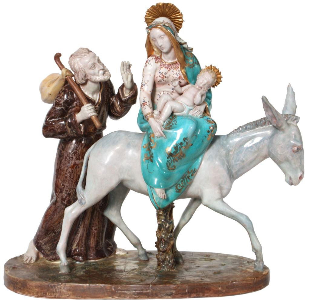 E. Pattarino Italian Madonna Sculpture: E. Pattarino Italian Madonna Sculpture. Colorful earthenware sculpture with Madonna and child on the back of a donkey, accompanied by Joseph walking along side. Signed on the side and on the bottom "P