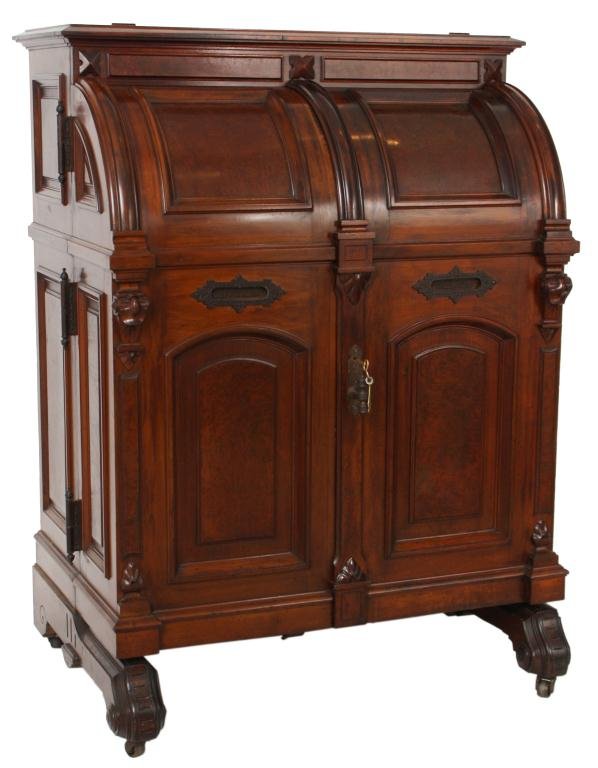 Standard Grade 3 Hinge Wooton Desk: Standard Grade 3 Hinge Wooton Desk. Large walnut desk has 2 doors which curve at the top w/ burled inserts, burled panels and carved trim with original hardware on the front, the reverse side of the d
