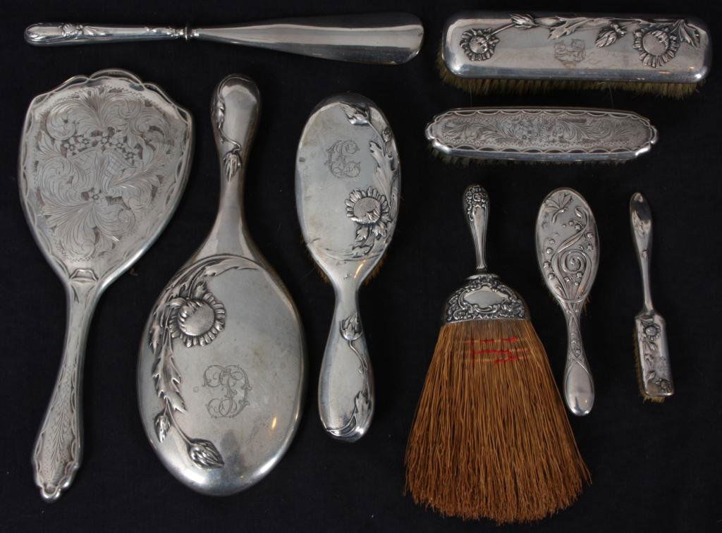 9 Pc Silver Dresser Set: 9 Pc Silver Dresser Set. This is an assembled set which includes 2 hand mirrors, shoe horn and 6 various brushes, each with silver backs and handles; pieces are marked with German 800 silver hallmarks
