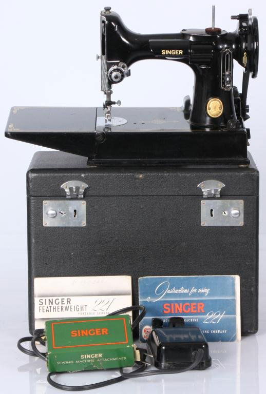 Singer Model 221 Sewing Maching: Singer Featherweight Model 221 Sewing Machine Fine portable electric sewing machine in original case with attachments, and instruction booklet; in excellent condition. Case is 11 in. high x 14 in. lon