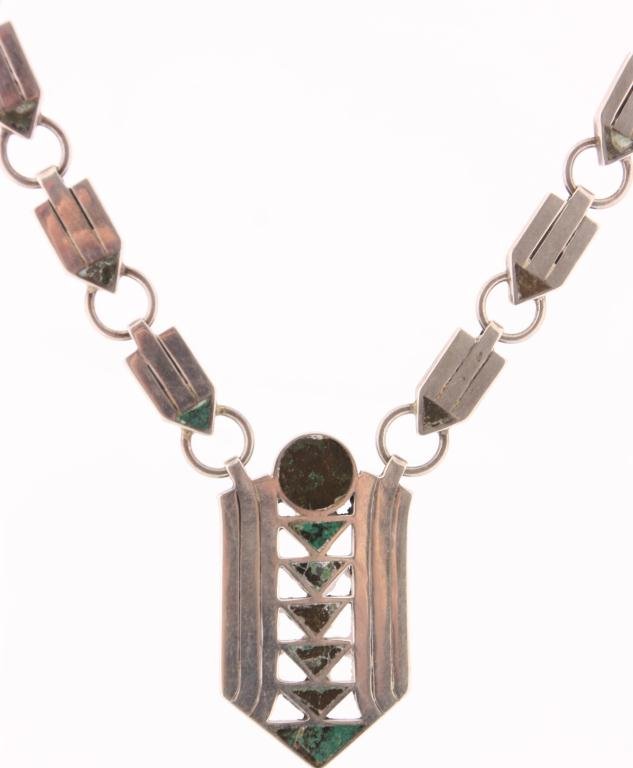 Silver & Turquoise Necklace: Silver & Turquoise Necklace. Silver pendent has a round turquoise piece over 6 descending triangles with 3 silver ribs on either side; the links are rectangular form with triangular bottoms attached b