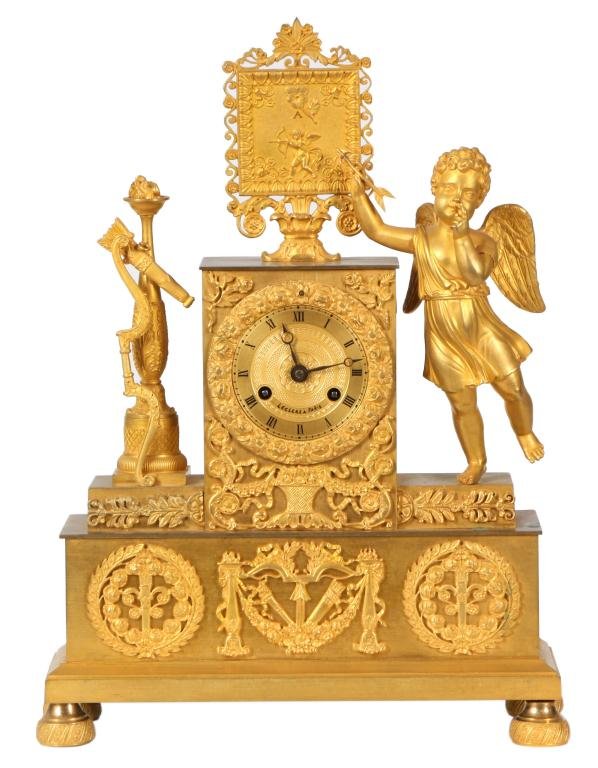 French Figural Silk Thread Clock: French Figural Silk Thread Clock. Dore bronze mantle clock depicts Amor as a teacher; the young winged figure of cupid stands on one foot using an arrow to point to a framed picture on the top of the 