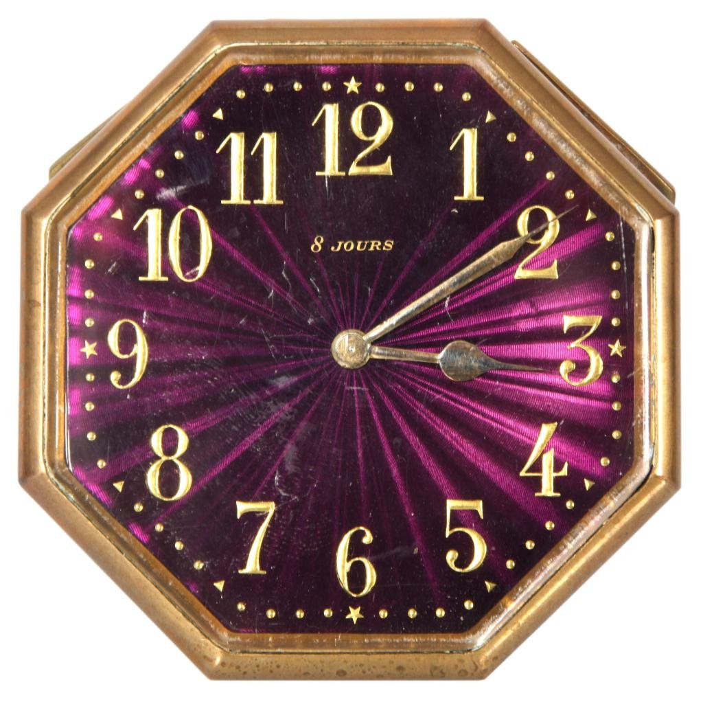 French Enamel Desk Clock: French Enamel Octagonal Desk Clock. Has a fancy purple guilloche enamel dial with gold Arabic hour numbers and gold hands, marked 8 Jours. Brass octagonal case has an 8 day spring driven movement; 3 i