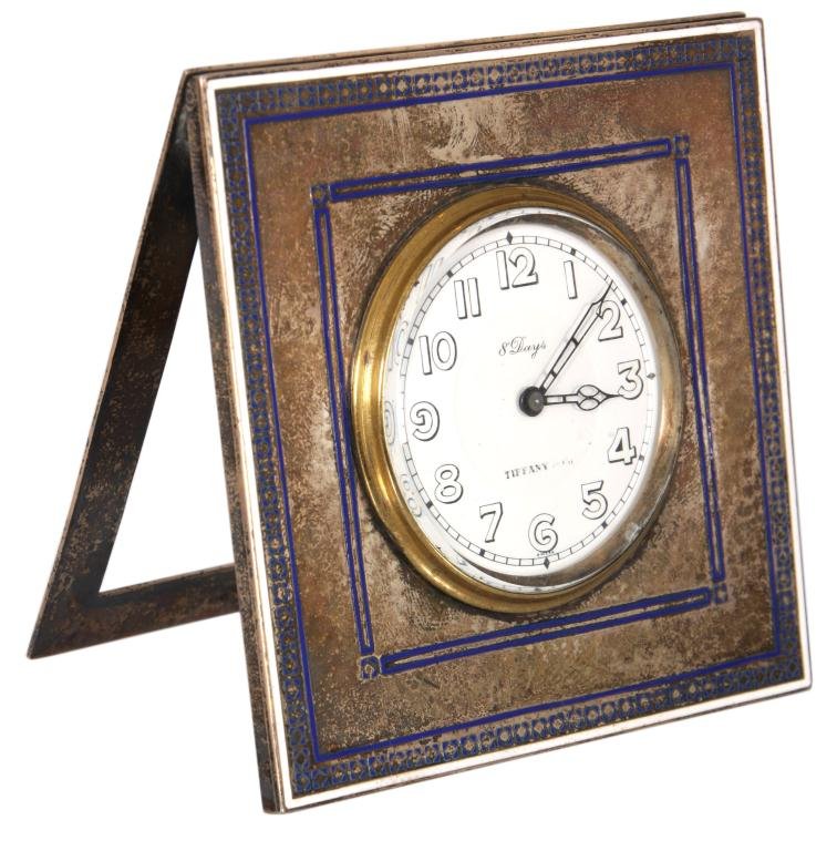 Tiffany Sterling & Enamel Clock: Tiffany Sterling & Enamel Desk Clock. Square sterling case with blue enamel borders; 1.75 in. enamel dial with Arabic numbers and pierced hands, signed Tiffany & Co. 8 day spring driven movement also 