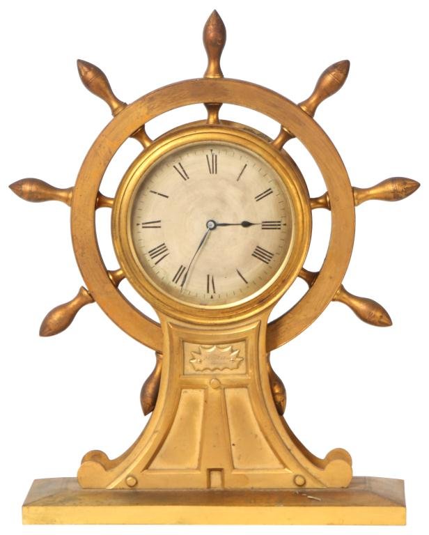 English Bronze Ships Wheel Clock: English Bronze Ships Wheel Clock. Blued hands, 4 in. silvered dial w/ black Roman hour numerals, brass time only movement w/ lever escapement, balance has good brisk motion. Quality ships helm bronze 