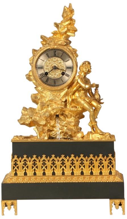 French Figural Silk Thread Clock: French Figural Silk Thread Mantle Clock. The dore bronze clock depicts the "Fountain of Youth", a spiral glass rod spins, resembling flowing water, has a separate spring driven movement built into the