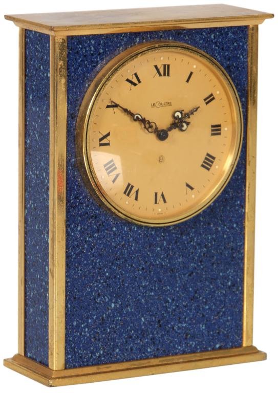 Le Coultre Lapis Lazuli Desk Clock: Le Coultre Lapis Lazuli Desk Clock. Gilt brass frame with blue lapis lazuli on 3 sides; 2.25 in. dial with Roman numerals and pieced hands, 8 day spring driven timepiece. 5 in. high x 3.5 in. wide x 1
