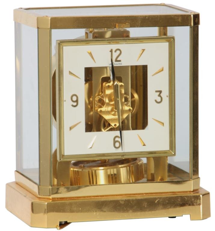 LeCoultre Perpetual Atmos Clock: LeCoultre Perpetual Atmos Clock. Brass desk clock has a square dial with applied brass 5 minute markers, 15 jewel movement exposed through the center of the dial. Clock is in good condition, pendulum 