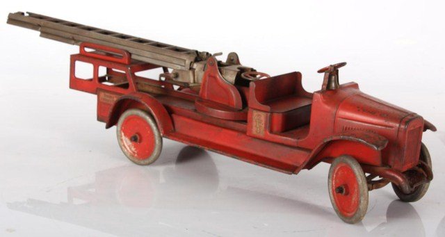 Vintage Buddy-L Aerial Ladder Truck: Vintage Buddy-L Aerial Ladder Truck. Large toy truck in original read paint; has Buddy L, aerial truck decal and C.F.D. decal on the sides. Paint is worn and has dings and scratches to the body and wh