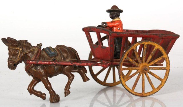 Antique Cast Iron Wagon: Antique Cast Iron Wagon. Drawn by a donkey, the red wagon has large yellow wheels, standing figure of a man in the back, has good old paint with typical wear. 5.5 in. high x 10.5 in. x 4 in.