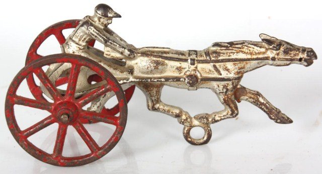 Cast Iron Chariot Racer Toy: Cast Iron Chariot Racer Toy. Original silver paint with original red wheels. 4 in. high x 7.25 x 2.5 in. wide