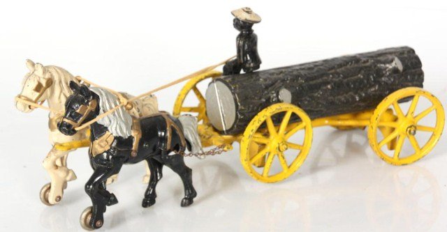Antique Cast Iron Toy: Antique Cast Iron Toy. Horse drawn logging wagon with a figural man seated on top. 15 in. long.
