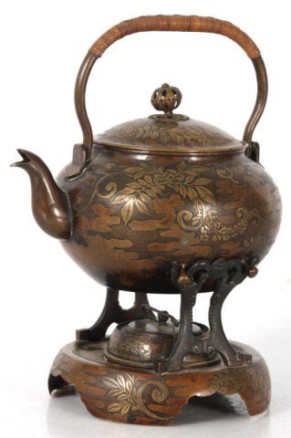 Chinese Copper Teapot on Burner: Chinese Copper Teapot on Burner. Fancy teapot with raised silver overlay foliate designs, has a domical lid with finial, matching stand with copper burner; in good condition, silver is worn, unsigned.