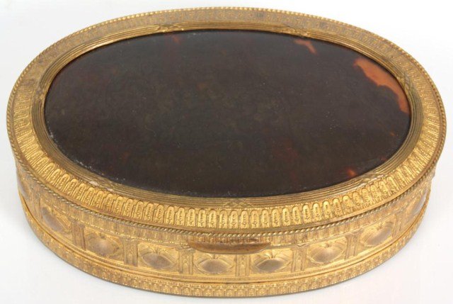 Brass & Tortoise Shell Box: Brass & Tortoise Shell Box. Oval gilt brass box with fancy geometric patterns and a domical tortoise shell insert in the lid; cloth lined interior, in good overall condition with no cracks in the lid.