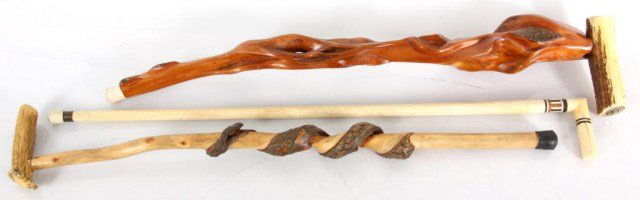 3 Pc Bone & Antler Canes: Lot of 3 Carved Walking Canes. Antler handle diamond willow cane, antler handle carved wood cane with natural bark carved serpent and a inlaid bone cane. Approx. 36 in. long