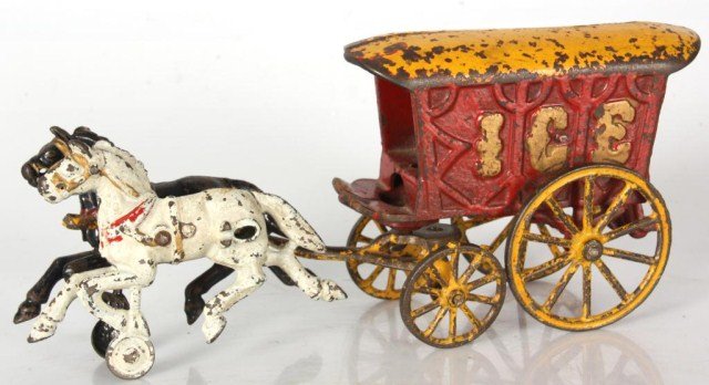 Cast Iron Toy Ice Wagon: Cast Iron Toy Ice Wagon. Horse drawn wagon with a white and black horse, red painted wagon with yellow trim and wheels and gold lettering on the sides. Has good original paint with typical wear and in
