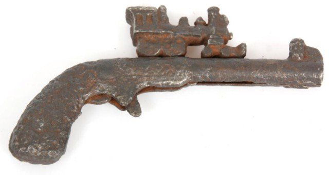 Excavated Cast Iron Cap Gun: Excavated Cast Iron Cap Gun. Child's toy cap gun with locomotive figure on top, in rusted excavated condition. 5 in. long.