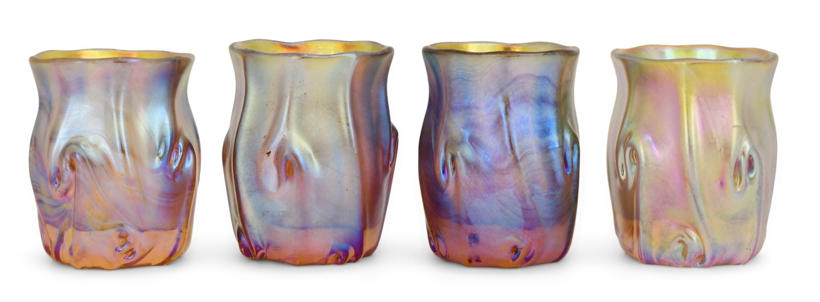 Four Tiffany Studios Favrile Glass Cordials: Tiffany Studios Four Cordials circa 1915 favrile glass each engraved "L.C.T." and individually numbered "M3586, M3630, M3582, M3481" 1 3/4 x 1 1/2 inches Provenance: The S. Broadley Theaker Collection