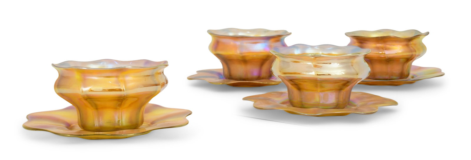Four Tiffany Studios Favrile Glass Bowls & Underplates: Tiffany Studios Four Bowls & Underplates circa 1915 favrile glass each with firm's engraved mark 2 1/4 x 4 inches (bowl) 6 in. diameter (underplate) Provenance: The S. Broadley Theaker Collection, Gla