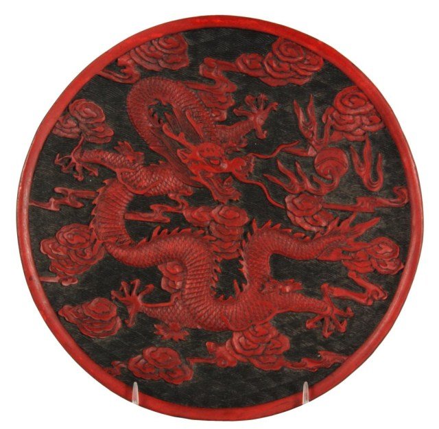 Cinnabar Plate with Dragon: Cinnabar Lacquer-ware Red on Black Plate with Dragon. On a ceramic (clay body) base, having a nice dragon design. Early 20th C. 7.75 in. dia.