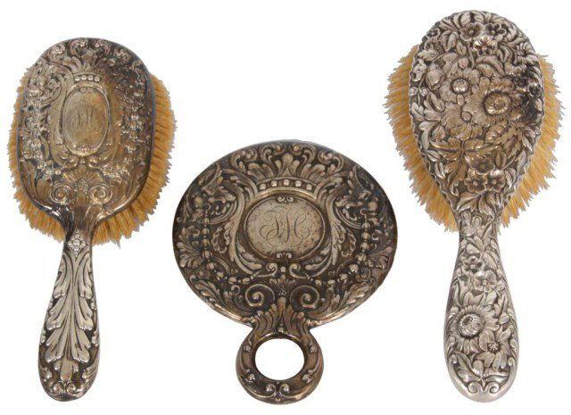 3 Pc. Sterling Repousse Dresser Pieces: 3 Pc. Sterling Repousse Dresser Pieces. Includes Tiffany & Co. brush with leafy scrolling design and monogram, Tiffany & Co. hand mirror with leafy scrolling design and monogram and a 9 in. sterling s