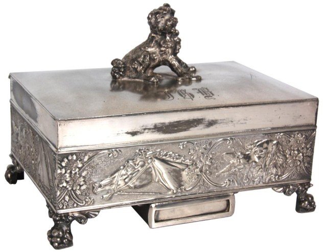 James Tufts Silver Figural Humidor: James Tufts Silver Figural Humidor. Silver plated box with figural dog on the lid, monogram JGB, low relief border on the sides with hinting dog, horse, ships and filigree on 4 claw feet; slide out ma