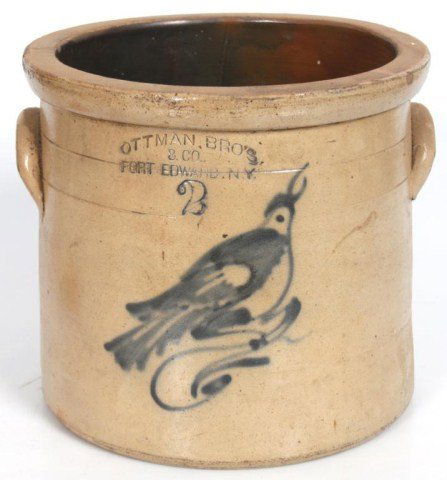 2 Gallon Stoneware Cobalt Crock: Ottman Bros & Co. Fort Edwards, NY; decorated with a cobalt bird on the front. 2 Gallon, 9 in. high x 10 in. dia. Few chips in rim, no hairlines.