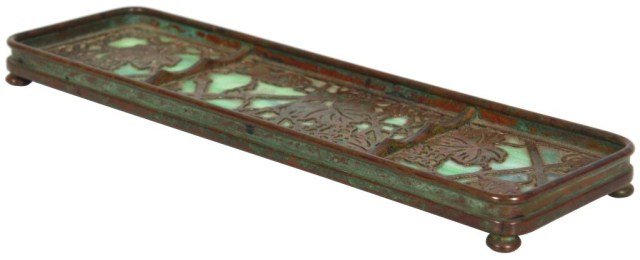 Tiffany Studios Grapevine Pen Tray: Tiffany Studios Grapevine Pen Tray. Bronze pen tray has a rectangular form with pierced grapevine pattern overlay on a singled piece of green glass, stands on spherical feet. Has a medium brown patina