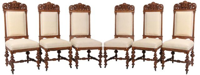 Set of 6 Carved Oak Dining Chairs: Set of 6 Carved Oak Dining Chairs. Mythical lions head carving on the crests with seashell foreheads and pierced carved swirled carving on the sides, has turned and fluted side posts with carved and t