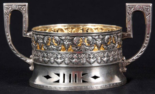 Russian Silver Wine Coaster: Russian Silver Wine Coaster. Round form with ornate handles on the sides, has a pierced swirling filigree border at the rim, pierced design at the foot and gold washed interior. Hallmarks on the botto