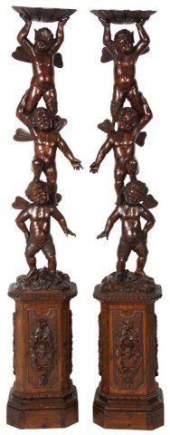 Pr Figural Carved Putti Pedestals: Pr Figural Carved Putti Pedestals. Black Forest carved figural pedestals with a young satyr standing on the shoulders of a winged putti, who is standing on the shoulders of another winged putti, the s