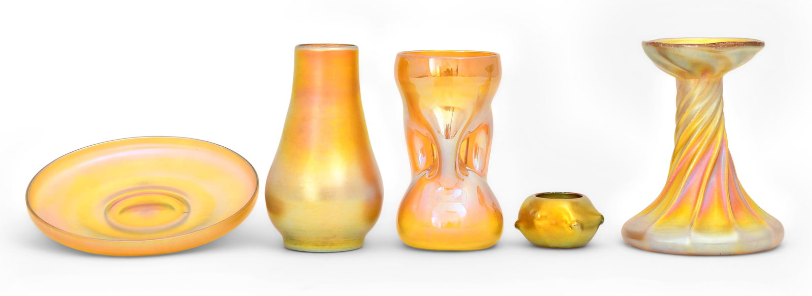 Five Tiffany Studios Favrile Glass Pieces: Tiffany StudiosFive Piecesearly 20th centuryfavrile glasscomprising a plate, candlestick, bowl and two vaseseach marked to the underside5 x 4 inches (largest)Provenance: Private Collection, Cliffo