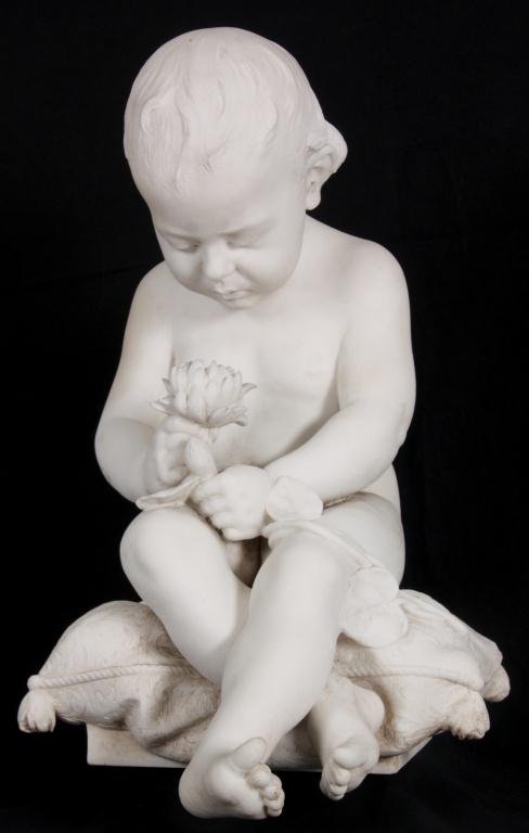 G. Trentanove Carrara Marble Sculpture: Gaetano Trentanove (1858-1937 Italy, U.S.) Carrara Marble Sculpture - Baby. The Figure of a baby is seated on a pillow, legs crossed as it gazes down at a chrysanthemum held in its hand. Finely carved